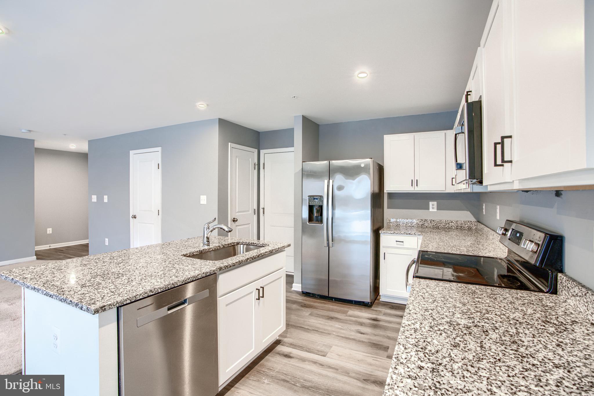 104 Magnolia Drive Elkton, MD 21921 - Photo 12 of 52 a kitchen with stainless steel appliances granite countertop a sink stove and refrigerator
