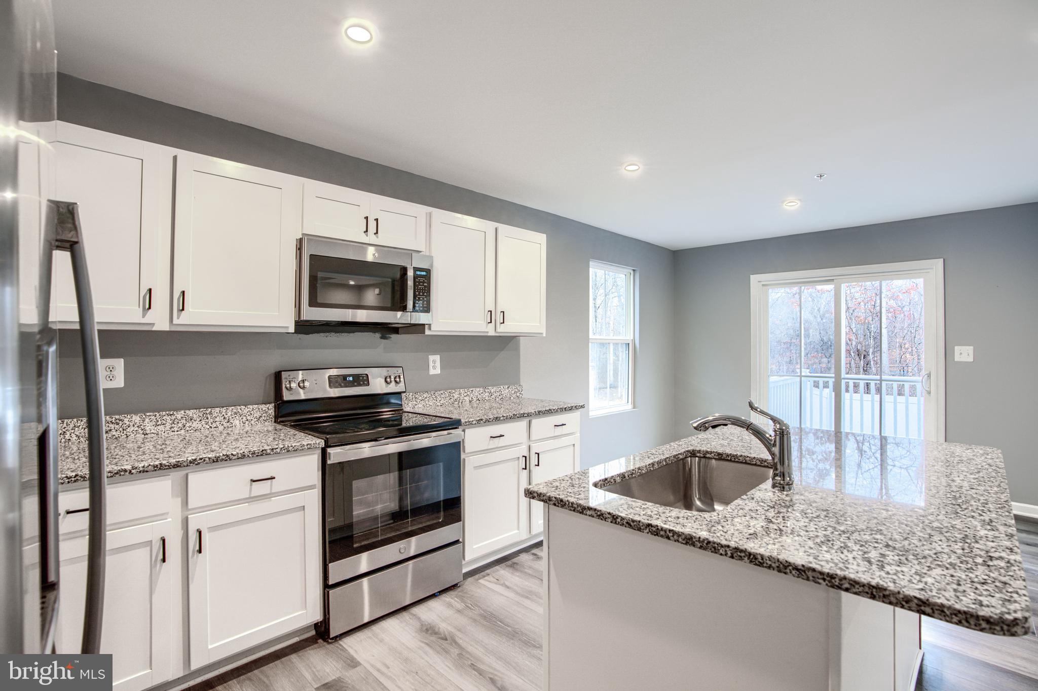 104 Magnolia Drive Elkton, MD 21921 - Photo 14 of 52 a kitchen with granite countertop a sink a stove and cabinets