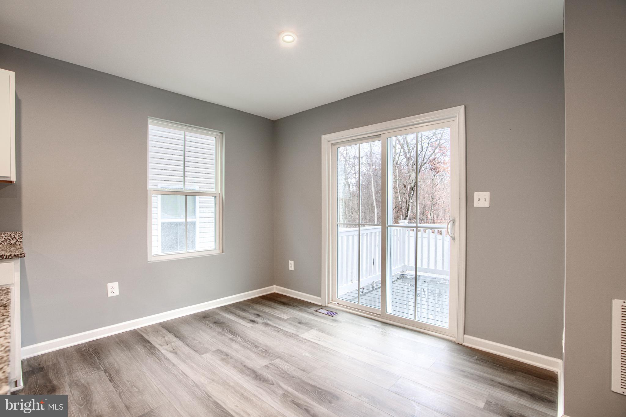 104 Magnolia Drive Elkton, MD 21921 - Photo 9 of 52 an empty room with wooden floor and windows