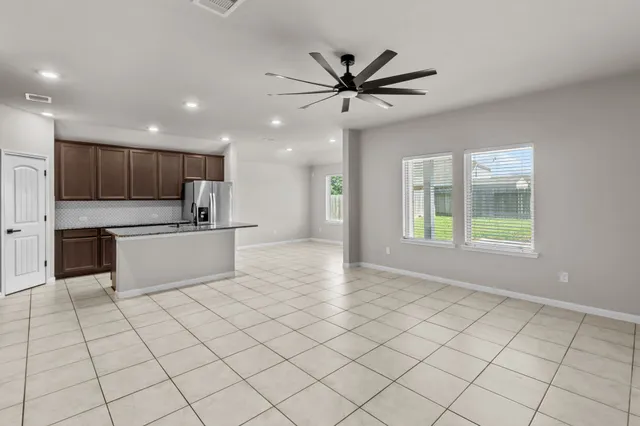 a view of kitchen with stainless steel appliances granite countertop a stove a sink and a refrigerator