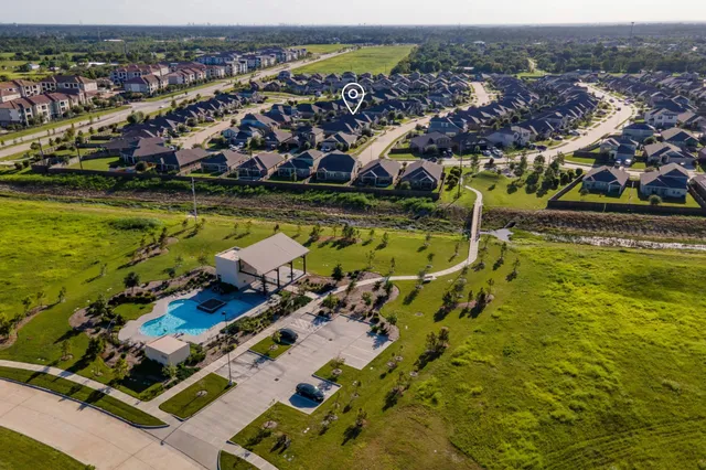 an aerial view of residential houses with outdoor space