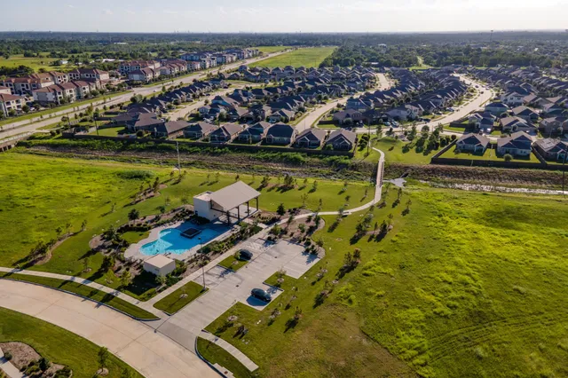 an aerial view of residential houses with outdoor space