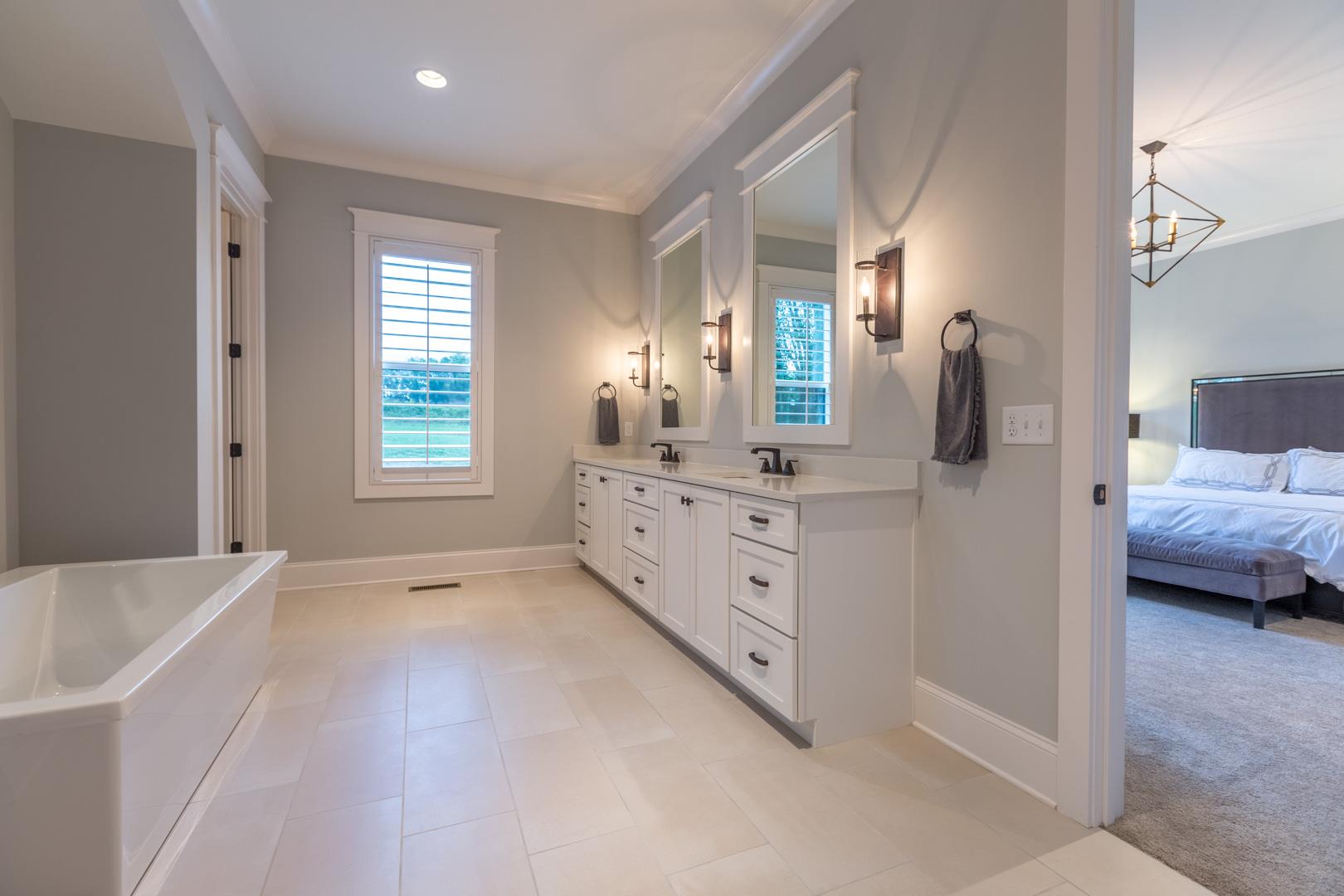 4119 Old Light Circle Arrington, TN 37014 - Photo 16 of 25 a bathroom with a tub sink and mirror