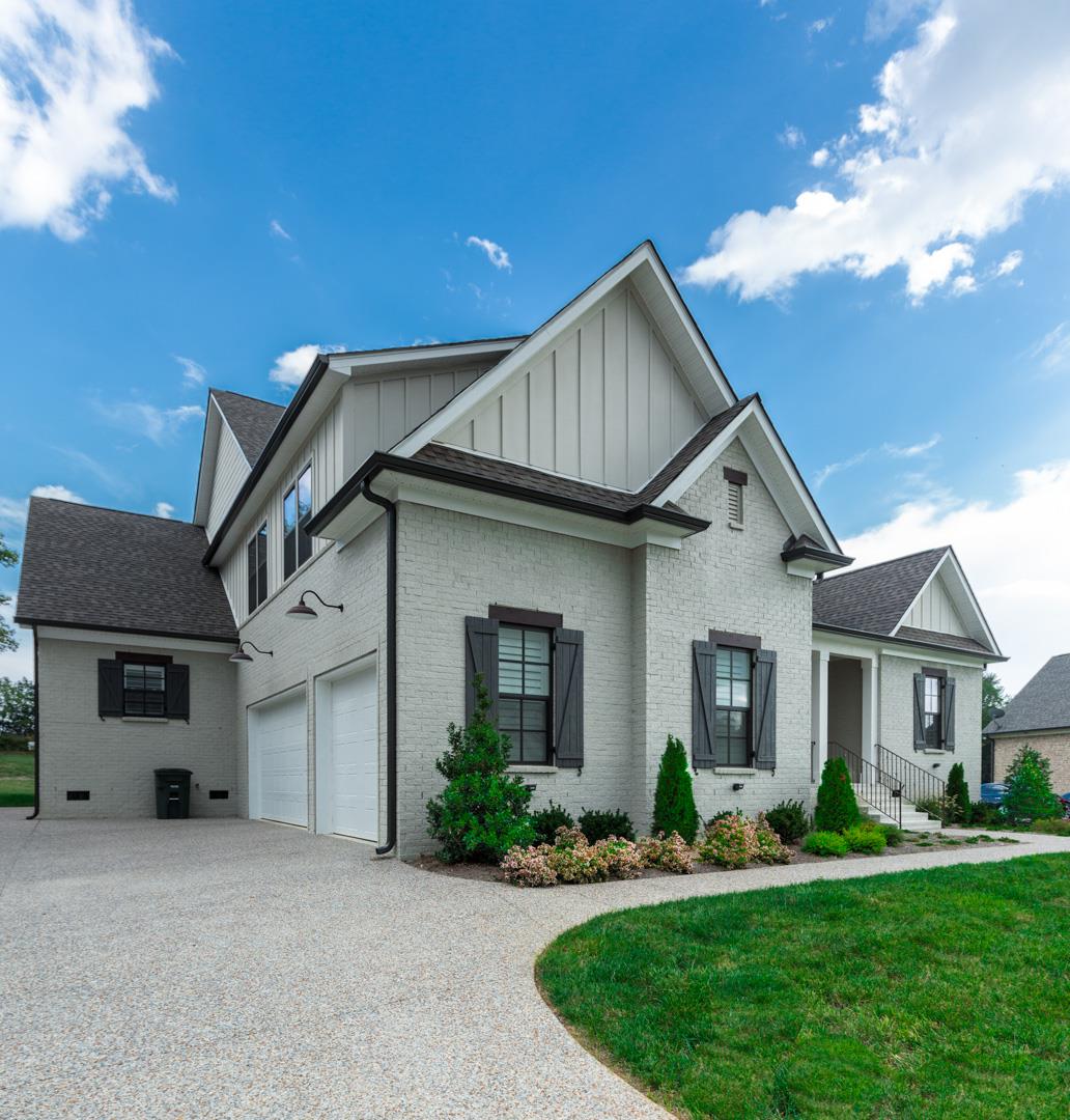4119 Old Light Circle Arrington, TN 37014 - Photo 2 of 25 a front view of a house with a yard and porch