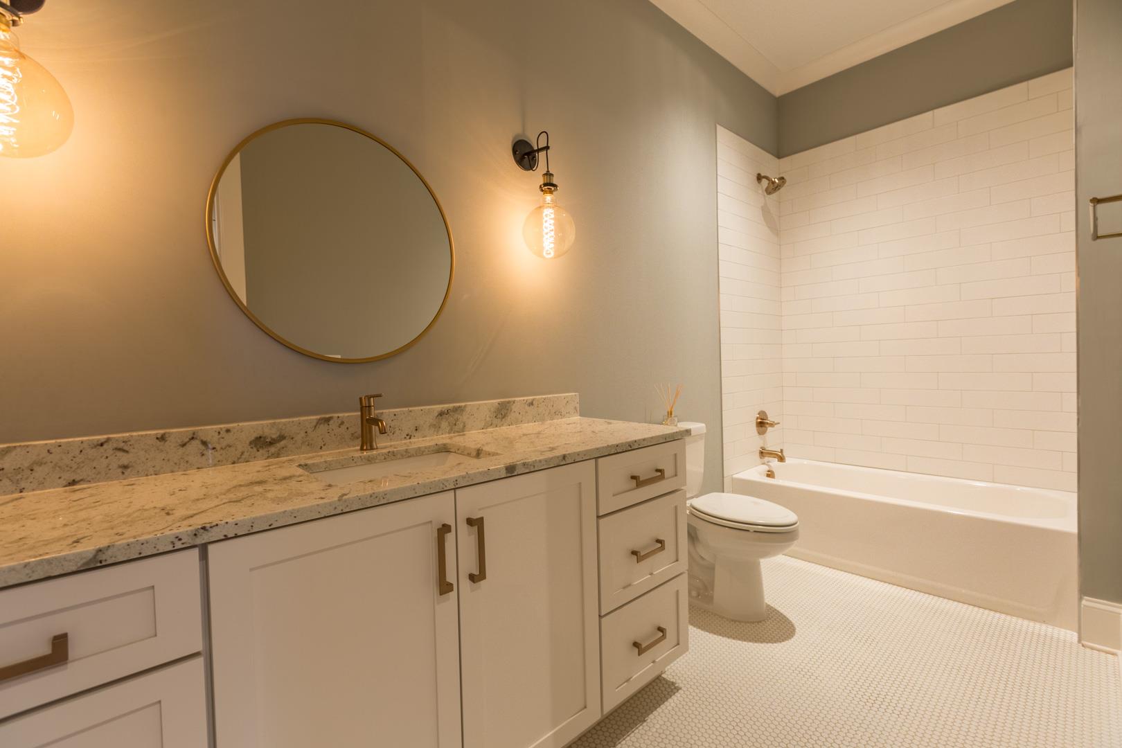 4119 Old Light Circle Arrington, TN 37014 - Photo 23 of 25 a bathroom with a granite countertop toilet sink and mirror