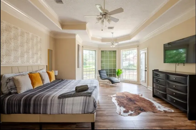 a bedroom with a bed and a flat screen tv