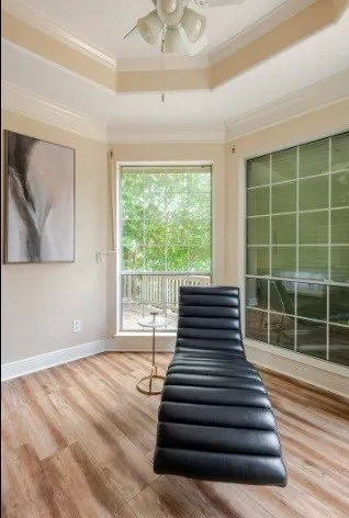 a view of a room with wooden floor and windows