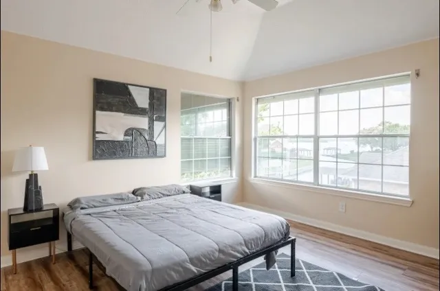 a bedroom with a bed and a large window