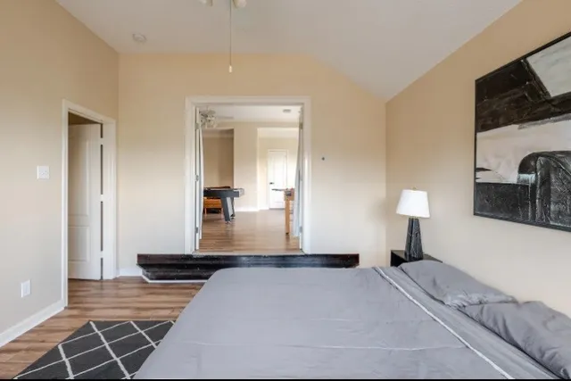 a bedroom with a bed and flat screen tv
