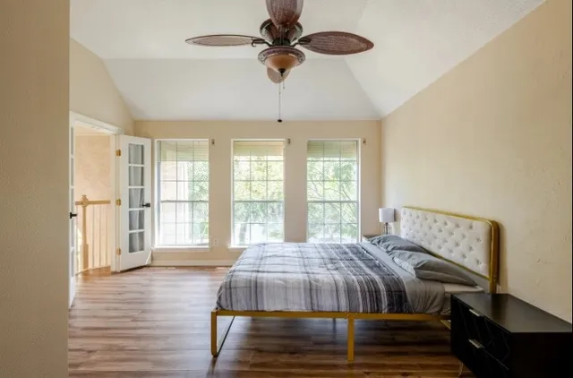 a bedroom with a bed dresser and a window