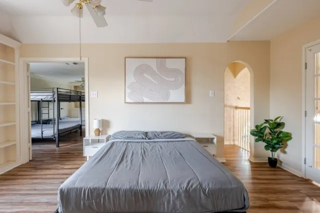 a bedroom with a bed and a potted plant