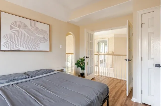 a bedroom with a bed and a painting on the wall