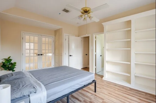 a bedroom with a bed and a chandelier
