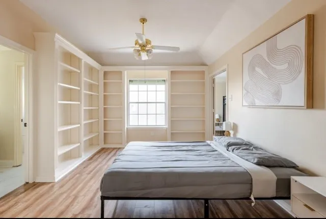 a bedroom with a bed and a window