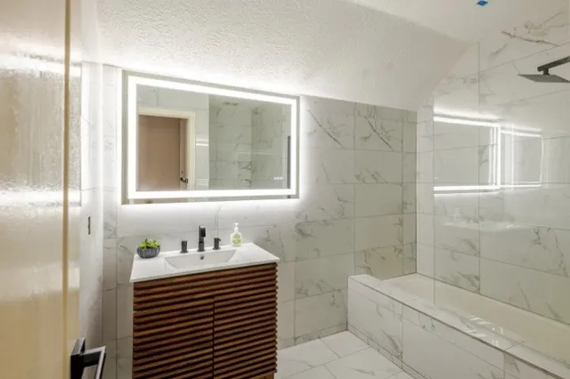 a bathroom with a sink a toilet and shower