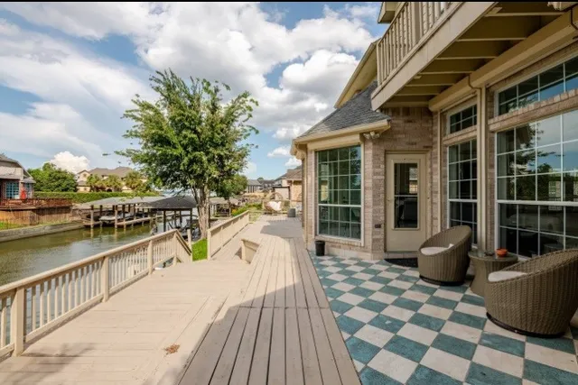 a view of a balcony with chair and wooden floor