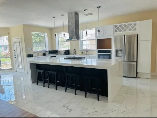 a large kitchen with a table and chairs