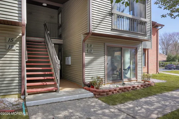 a view of a house with a yard and stairs