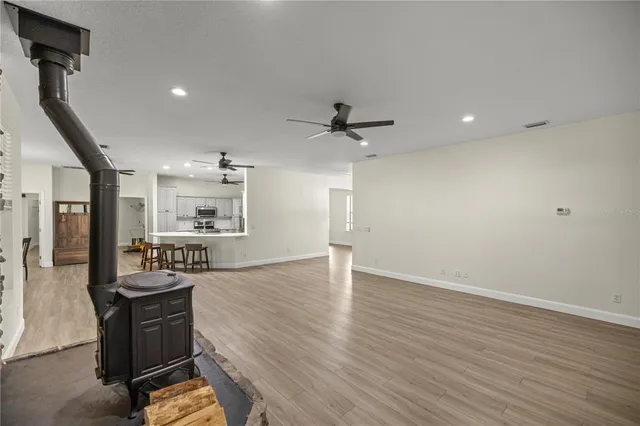 a view of a kitchen with wooden floor and electronic appliances