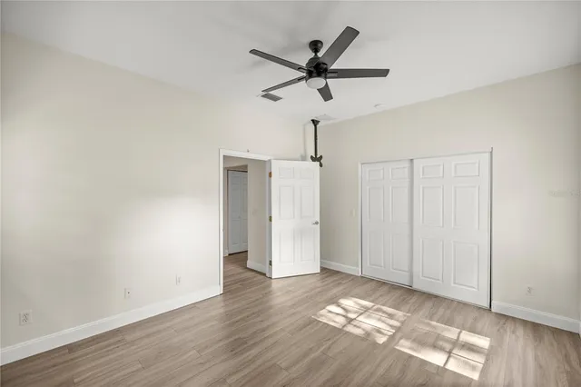 a room and a window with a ceiling fan
