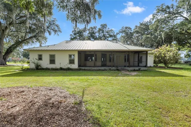 a view of a house with a yard and tree