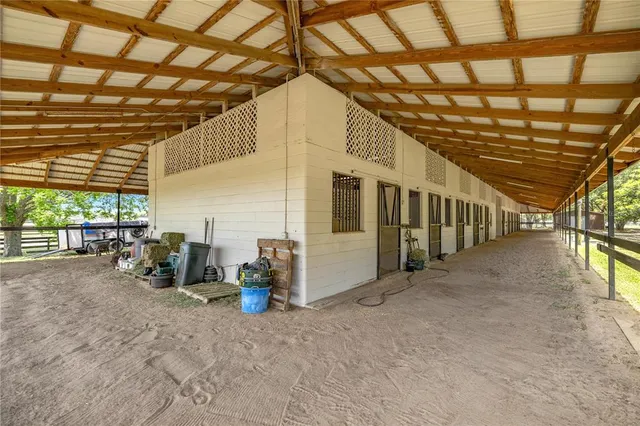 a view of a house with a yard and large tree