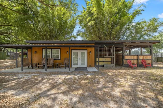 a kitchen with stainless steel appliances kitchen island granite countertop a sink refrigerator and cabinets