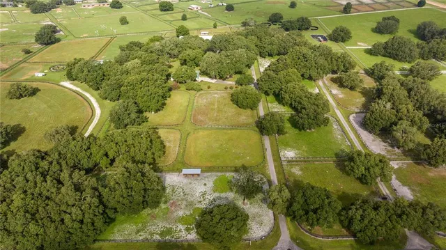 a aerial view of a residential houses with yard