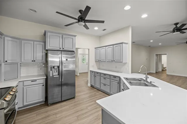 a kitchen with a refrigerator a sink and cabinets