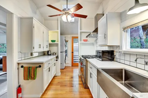 a kitchen with stainless steel appliances kitchen island granite countertop a sink and cabinets