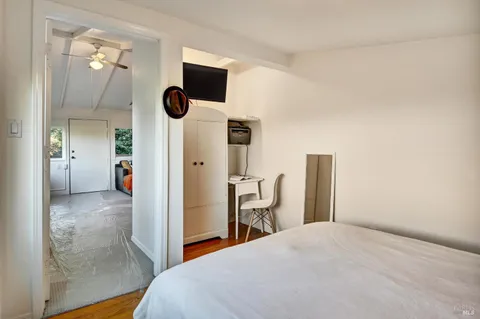 a bedroom with a bed and a television