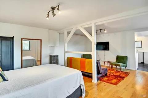 a bedroom with a bed and wooden floor