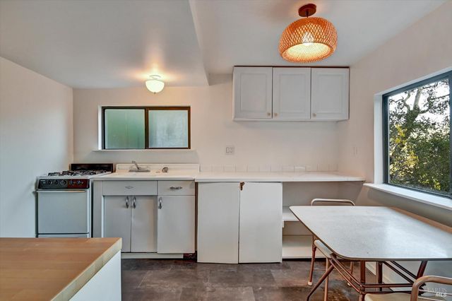 a kitchen with cabinets and window