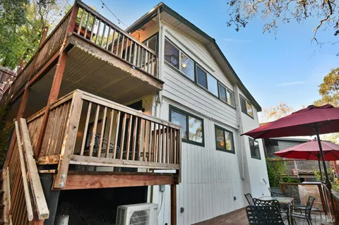 a view of a house with backyard and sitting area