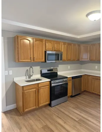 a kitchen with a stove a sink and a microwave