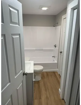 a bathroom with a toilet and a shower