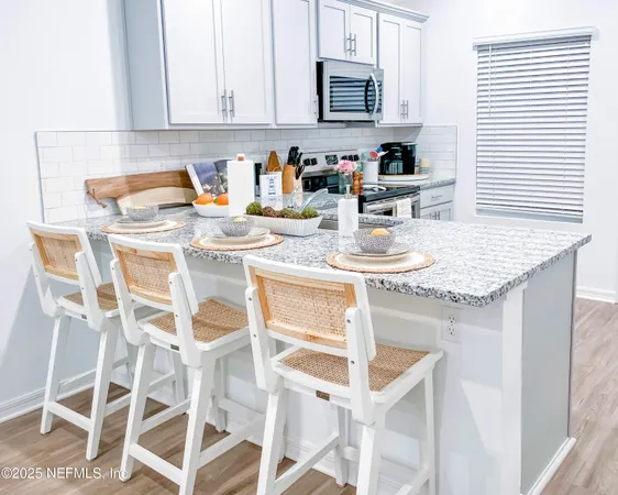 a utility room with cabinets washer and dryer