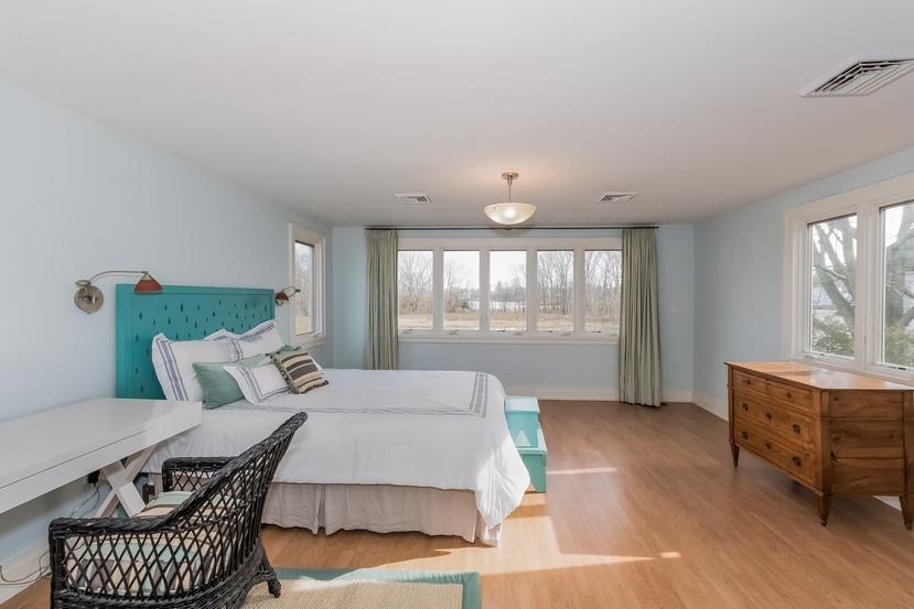 63 Roton Avenue Rowayton, CT 06853 - Photo 17 of 30 a spacious bedroom with a bed and a window