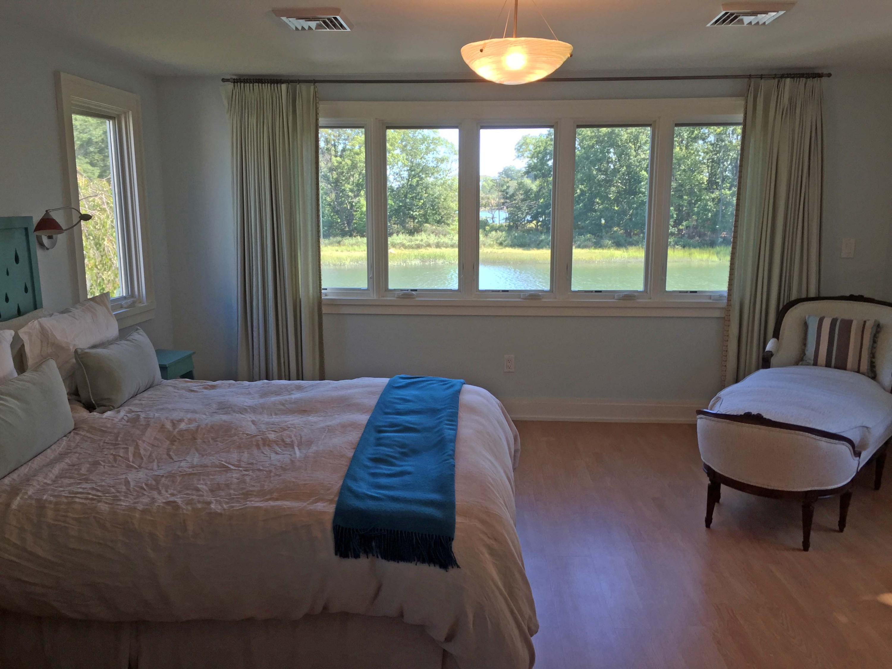 63 Roton Avenue Rowayton, CT 06853 - Photo 18 of 30 a bedroom with a bed and a chair