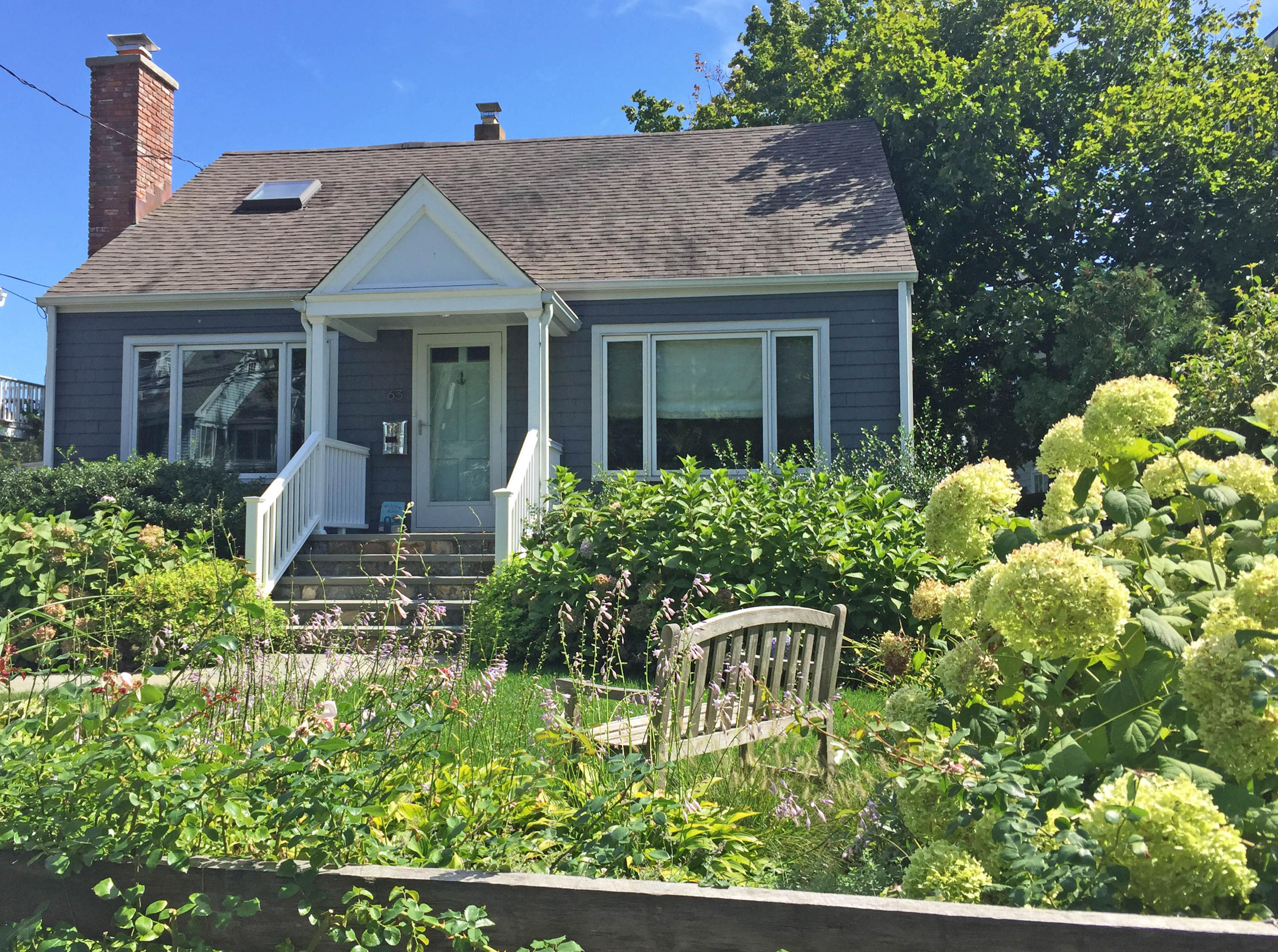 63 Roton Avenue Rowayton, CT 06853 - Photo 2 of 30 a front view of a house with a yard