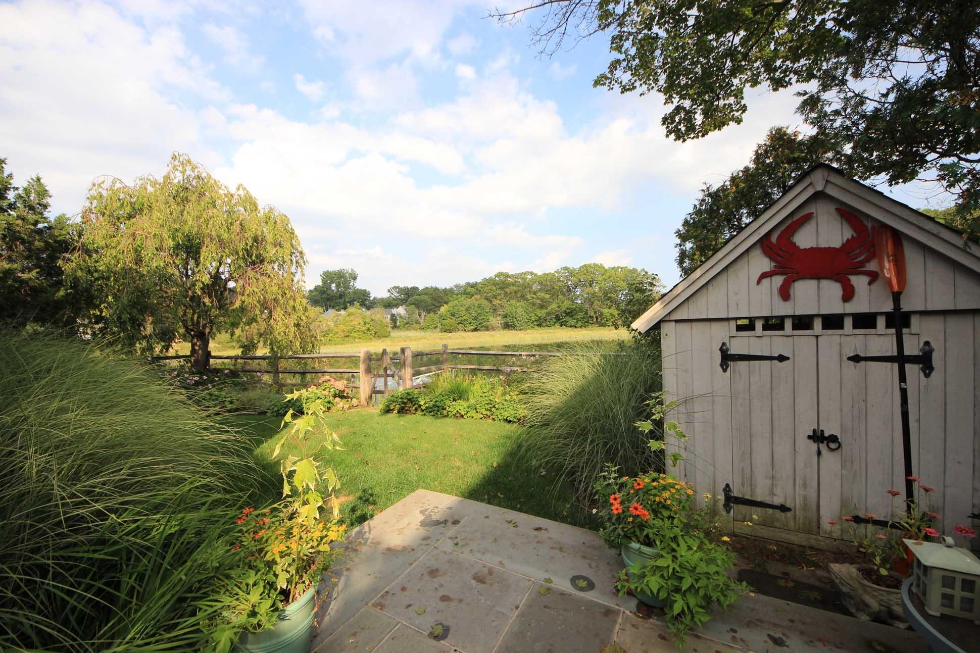 63 Roton Avenue Rowayton, CT 06853 - Photo 23 of 30 a view of a lake with a house in the background