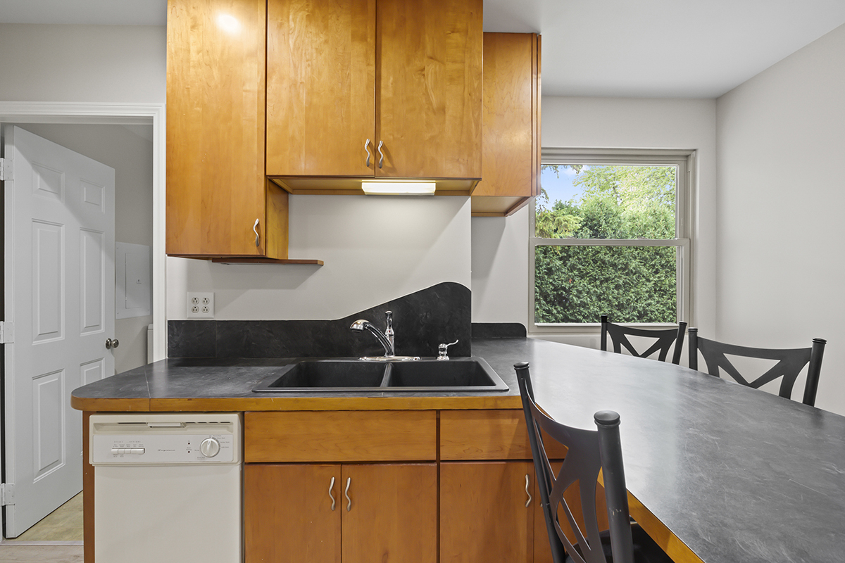 2900 Swallow Lane Rolling Meadows, IL 60008 - Photo 13 of 37 a kitchen with a sink a table and chairs in it