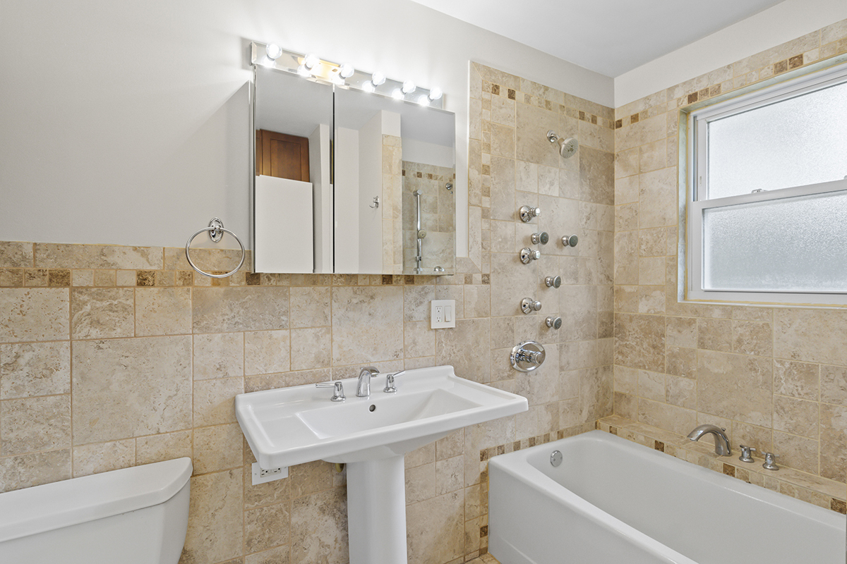 2900 Swallow Lane Rolling Meadows, IL 60008 - Photo 22 of 37 a bathroom with a sink a toilet and shower