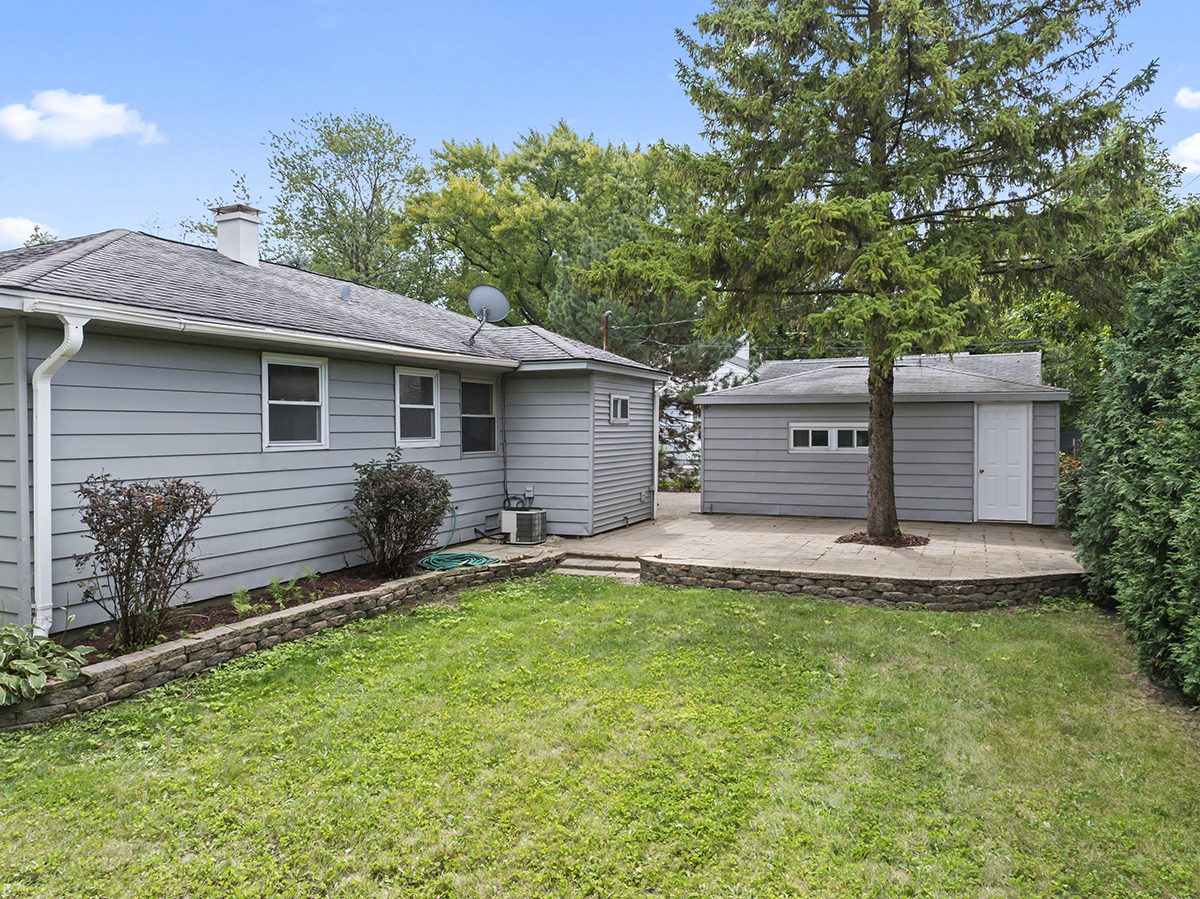 2900 Swallow Lane Rolling Meadows, IL 60008 - Photo 26 of 37 a front view of a house with a yard and garage