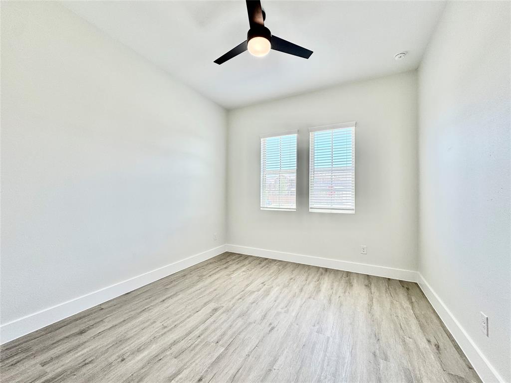 8513 Shorehan Road The Colony, TX 75056 - Photo 15 of 25 Empty room with wood finished floors, baseboards, a ceiling fan, and a smoke detector