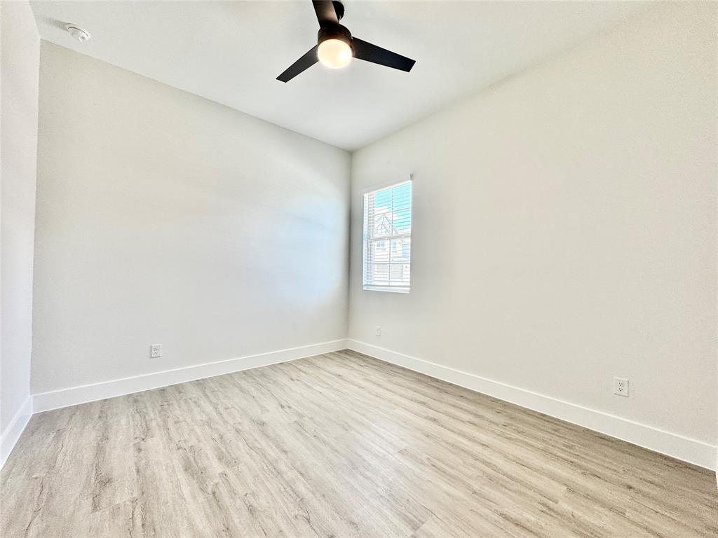 8513 Shorehan Road The Colony, TX 75056 - Photo 17 of 25 Unfurnished room featuring wood finished floors and baseboards