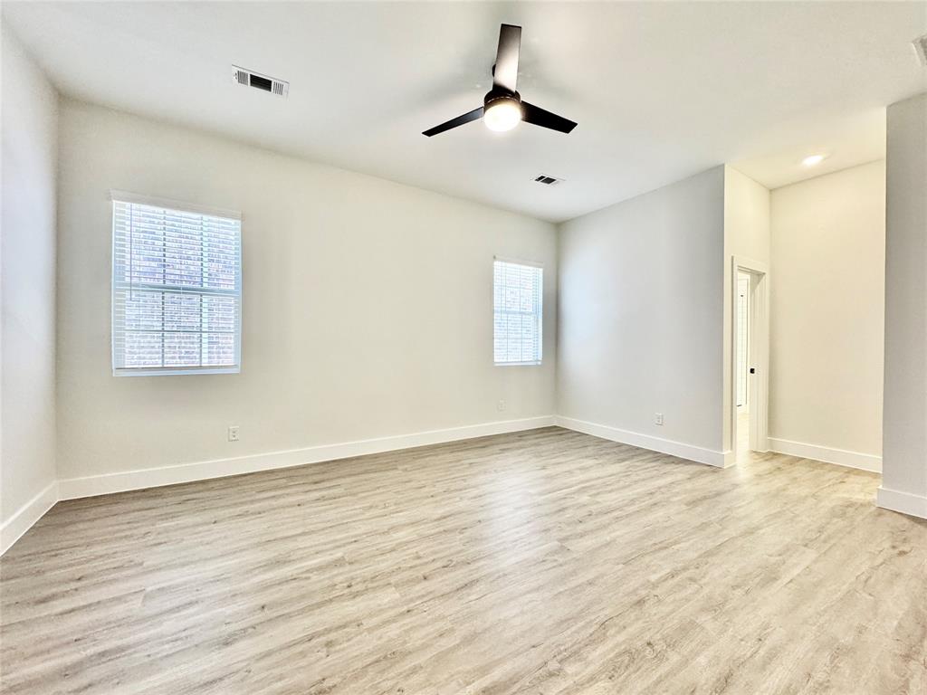 8513 Shorehan Road The Colony, TX 75056 - Photo 8 of 25 Spare room with wood finished floors, a ceiling fan, and baseboards