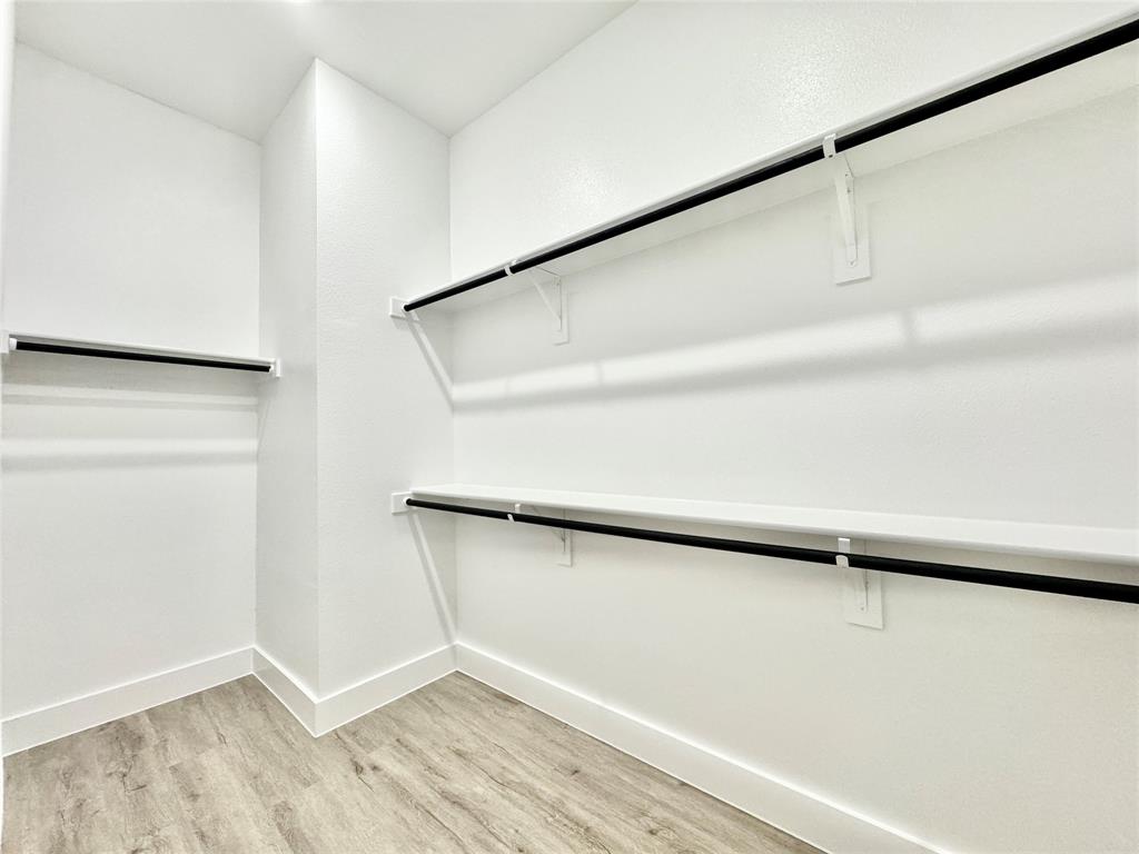 8513 Shorehan Road The Colony, TX 75056 - Photo 10 of 25 Walk in closet with light wood-style flooring