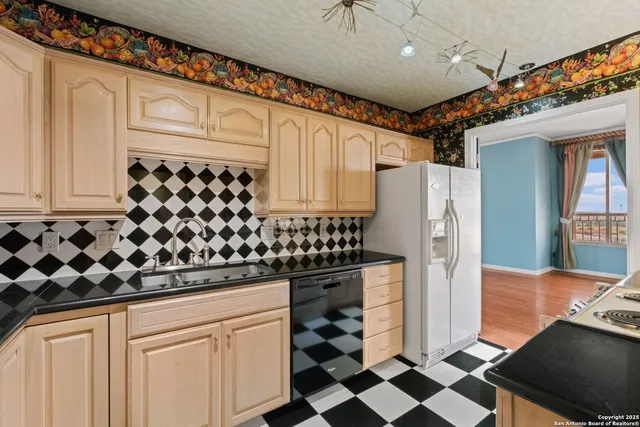 a kitchen with stainless steel appliances a refrigerator and cabinets