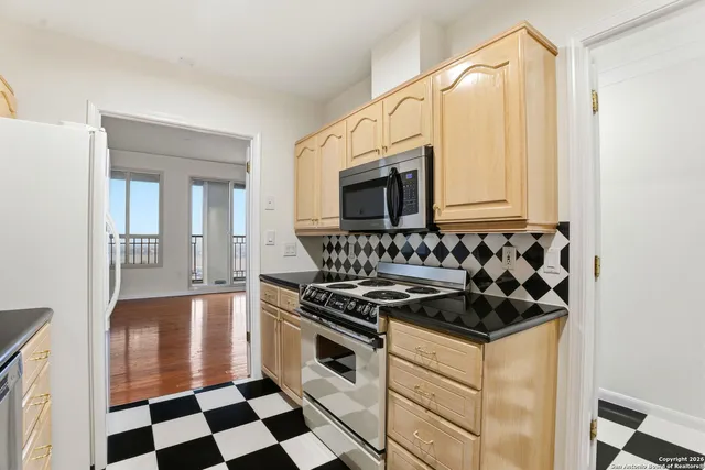 a big room with wooden floor and windows
